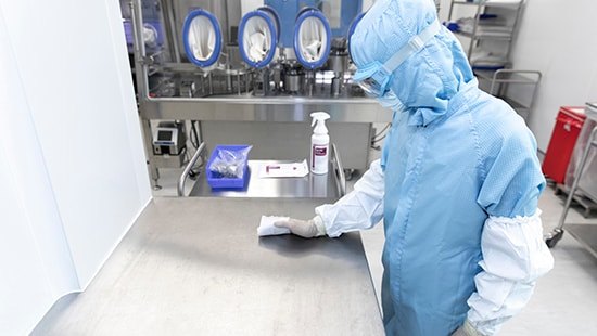 Operator wiping a stainless surface with a Klercide pouch wipe
