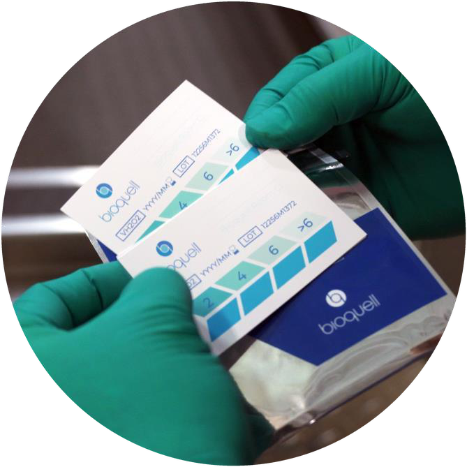 Gloved hands holding Bioquell chemical indicators